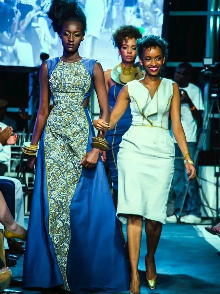 A runway finale: the designer walks hand-in-hand with models wearing her patterned blue and cream collection.